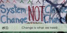 sign reading "system change not climate change"
